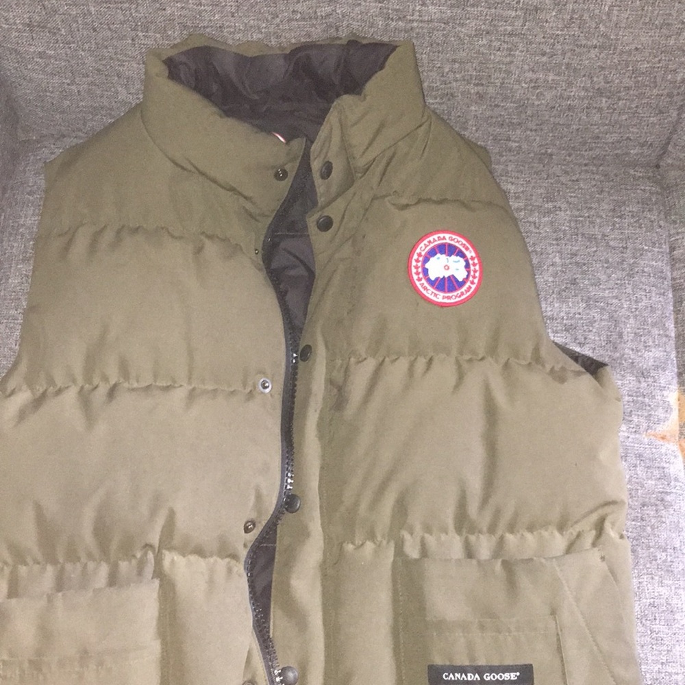 This is a dark green Canada goose vest
